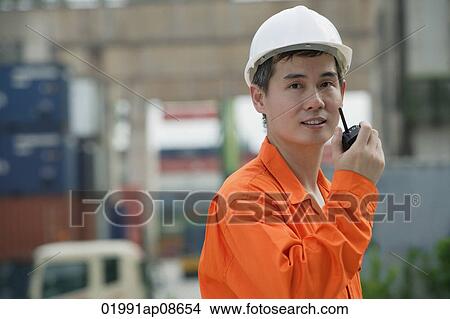 Construction worker talking on walkie talkie View Large Photo Image Picture - Construction worker talking on walkie talkie. Fotosearch