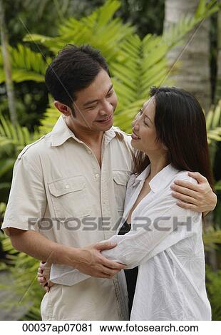 Couple embracing, outdoors View Large Photo Image Stock Image - Couple embracing, outdoors. Fotosearch