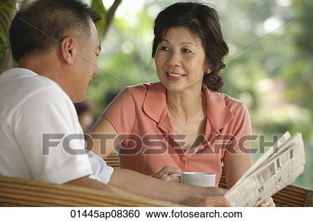 Stock Image - Couple enjoying tea at a cafe. Fotosearch