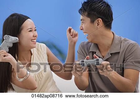 Couple playing video games View Large Photo Image Stock Photograph - Couple playing video games. Fotosearch