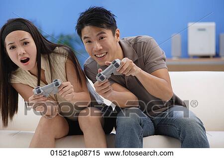 Couple playing video games View Large Photo Image Stock Photography - Couple playing video games. Fotosearch