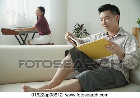 Stock Image - Couple relaxing at home. Fotosearch