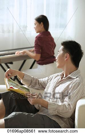 Couple relaxing at home View Large Photo Image Stock Image - Couple relaxing at home. Fotosearch