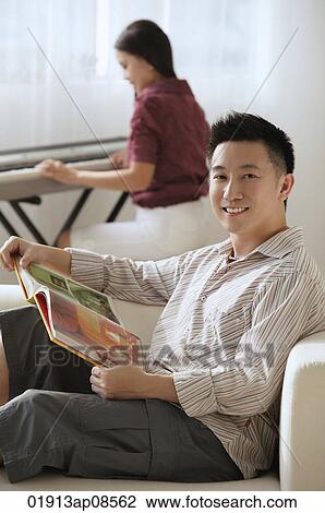 Stock Image - Couple relaxing at home. Fotosearch