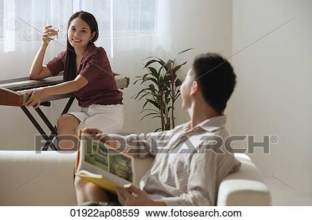 Couple relaxing at home View Large Photo Image Stock Photo - Couple relaxing at home. Fotosearch