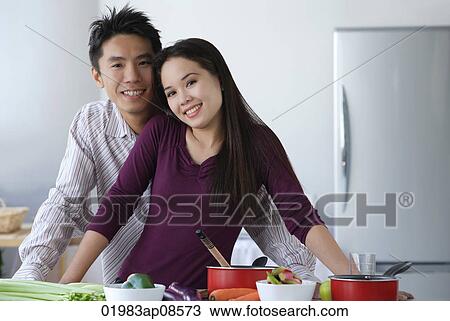 Couple together in the kitchen View Large Photo Image Stock Image - Couple together in the kitchen. Fotosearch