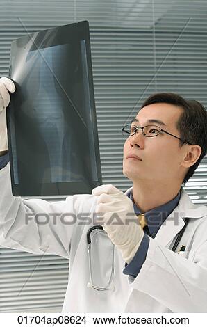 Doctor examining x-rays of knee View Large Photo Image Picture - Doctor examining x-rays of knee. Fotosearch