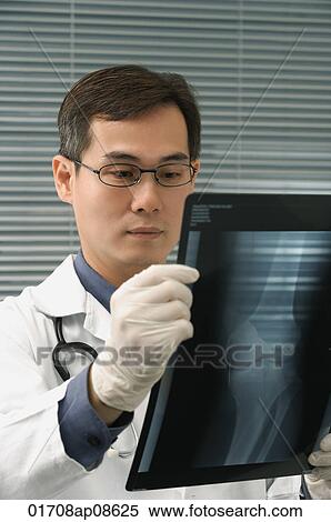 Doctor examining x-rays of knee View Large Photo Image Stock Photography - Doctor examining x-rays of knee. Fotosearch