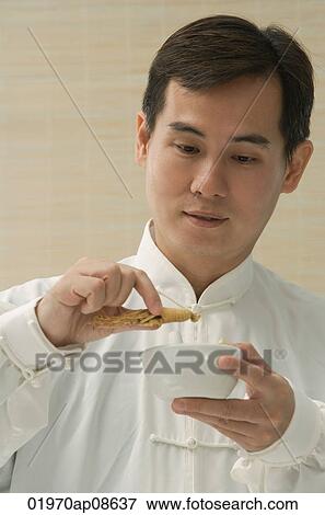 Stock Photo - Doctor experimenting with traditional Chinese medicine. Fotosearch
