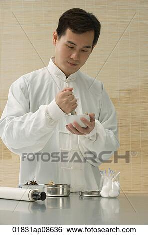 Doctor experimenting with traditional Chinese medicine View Large Photo Image Stock Photograph - Doctor experimenting with traditional Chinese medicine. Fotosearch