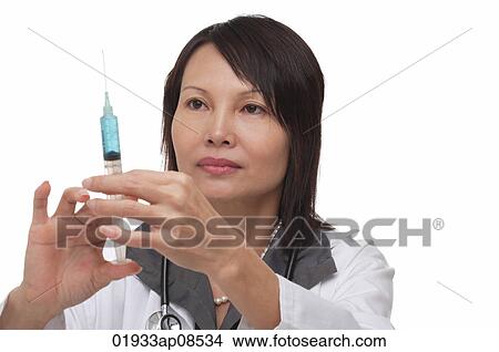 Doctor holding syringe View Large Photo Image Picture - Doctor holding syringe. Fotosearch