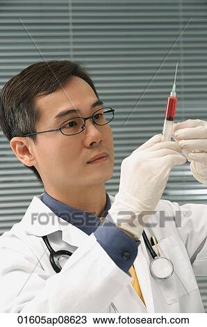Doctor preparing hypodermic needle View Large Photo Image Stock Image - Doctor preparing hypodermic needle. Fotosearch