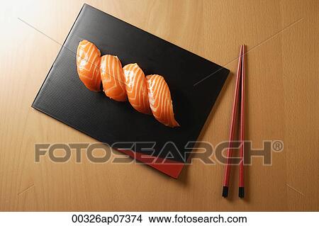 four pieces of salmon sushi, nigiri on rice ball, chopsticks View Large Photo Image Picture - four pieces of salmon sushi, nigiri on rice ball, chopsticks. Fotosearch
