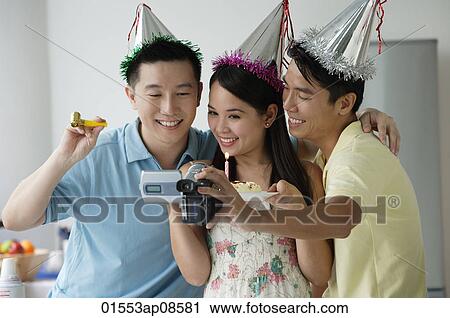Friends celebrating and videotaping it View Large Photo Image Stock Image - Friends celebrating and videotaping it. Fotosearch