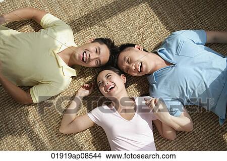 Friends lying on the floor laughing View Large Photo Image Picture - Friends lying on the floor laughing. Fotosearch