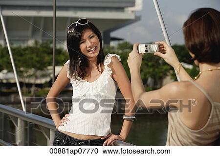 Friends take photos of each other on a bridge View Large Photo Image Stock Image - Friends take photos of each other on a bridge. Fotosearch