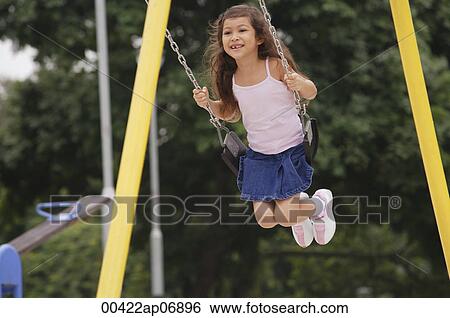 Girl on playground swing View Large Photo Image Stock Photograph - Girl on playground swing. Fotosearch