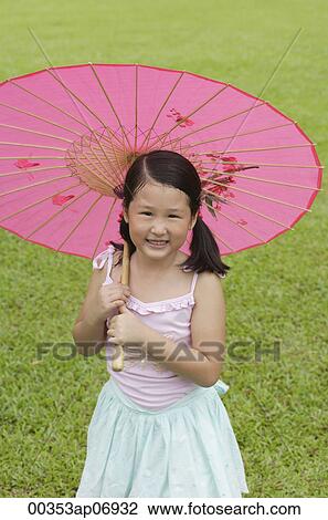 Girl using pink traditional Chinese paper umbrella View Large Photo Image Stock Image - Girl using pink traditional Chinese paper umbrella. Fotosearch