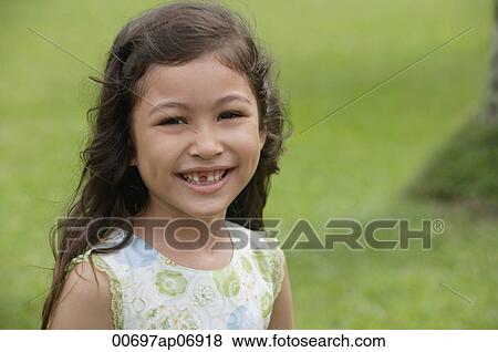 Stock Photo - Girl with gap-toothed smile, looking at camera. Fotosearch