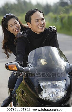 Man and woman on motorcycle View Large Photo Image Stock Image - Man and woman on motorcycle. Fotosearch