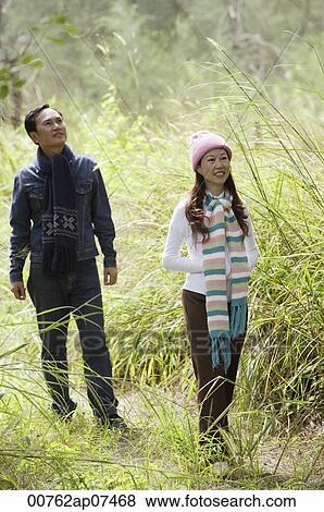 Man and woman walking through nature, outdoors, hiking View Large Photo Image Stock Photo - Man and woman walking through nature, outdoors, hiking. Fotosearch