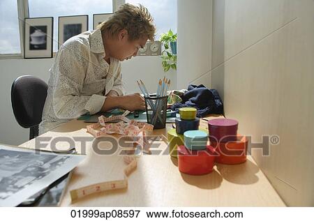 Man at desk drawing and measuring View Large Photo Image Stock Photo - Man at desk drawing and measuring. Fotosearch