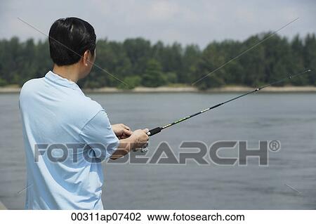 Man fishing with fishing pole, rear view View Large Photo Image Stock Image - Man fishing with fishing pole, rear view. Fotosearch