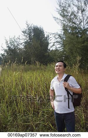 Man hiking outdoors, in woods, forest View Large Photo Image Stock Photo - Man hiking outdoors, in woods, forest. Fotosearch