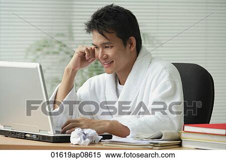 Man in bathrobe working at computer View Large Photo Image Stock Photography - Man in bathrobe working at computer. Fotosearch