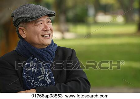 Man in the park smiling into distance View Large Photo Image Stock Image - Man in the park smiling into distance. Fotosearch