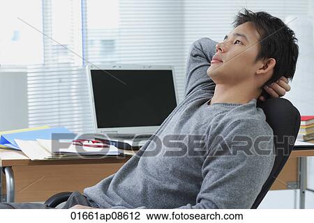 Man leaning back in office chair View Large Photo Image Stock Image - Man leaning back in office chair. Fotosearch