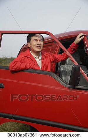 Man looking through window of open car door, outdoors, nature View Large Photo Image Stock Image - Man looking through window of open car door, outdoors, nature. Fotosearch