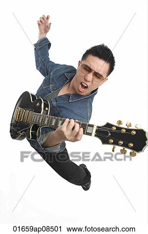Stock Image - Man playing guitar enthusiastically. Fotosearch