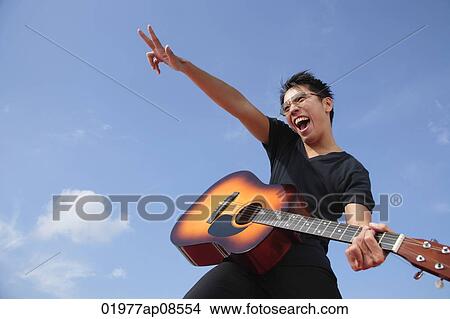 Man playing guitar outdoors View Large Photo Image Picture - Man playing guitar outdoors. Fotosearch