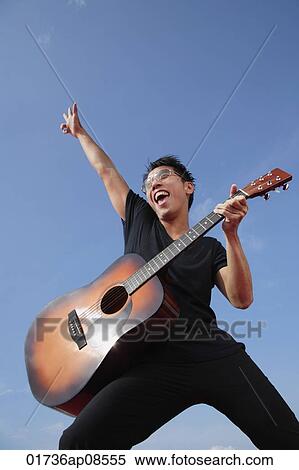 Man playing guitar outdoors View Large Photo Image Stock Photography - Man playing guitar outdoors. Fotosearch