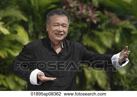 Man practicing Tai Chi in the park View Large Photo Image Stock Image - Man practicing Tai Chi in the park. Fotosearch