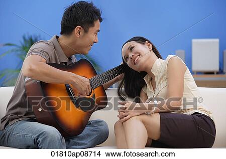 Man serenading young woman View Large Photo Image Picture - Man serenading young woman. Fotosearch