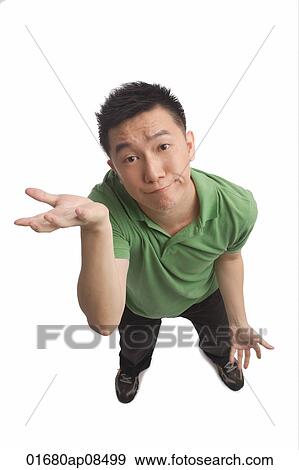 Stock Photo - Man shrugging while looking at camera. Fotosearch