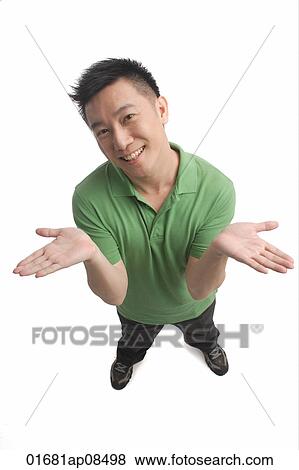 Man shrugging while smiling at camera View Large Photo Image Stock Photo - Man shrugging while smiling at camera. Fotosearch