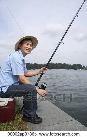 Man sitting on cooler, fishing with fishing pole View Large Photo Image Stock Photography - Man sitting on cooler, fishing with fishing pole. Fotosearch