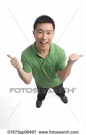 Man smiling at camera and giving two thumbs up View Large Photo Image Stock Photo - Man smiling at camera and giving two thumbs up. Fotosearch