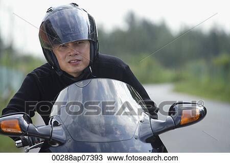 Man wearing helmet and riding motorcycle View Large Photo Image Stock Image - Man wearing helmet and riding motorcycle. Fotosearch