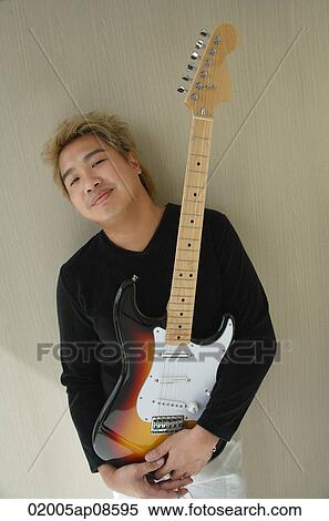 Man with guitar smiling at camera View Large Photo Image Stock Photography - Man with guitar smiling at camera. Fotosearch