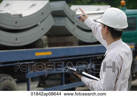 Man with hard helmet and clipboard View Large Photo Image Picture - Man with hard helmet and clipboard. Fotosearch