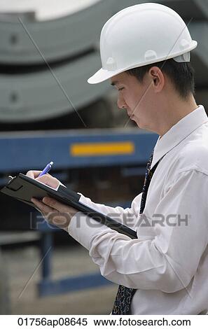 Man with hard helmet and clipboard View Large Photo Image Stock Photography - Man with hard helmet and clipboard. Fotosearch