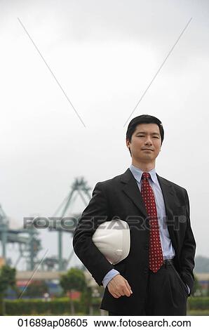 Man with hard helmet looking at camera View Large Photo Image Stock Photography - Man with hard helmet looking at camera. Fotosearch