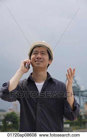 Man with hard helmet talking on the phone View Large Photo Image Stock Photo - Man with hard helmet talking on the phone. Fotosearch