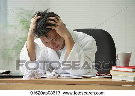 Man with head in his hands, looking frustrated View Large Photo Image Stock Photo - Man with head in his hands, looking frustrated. Fotosearch