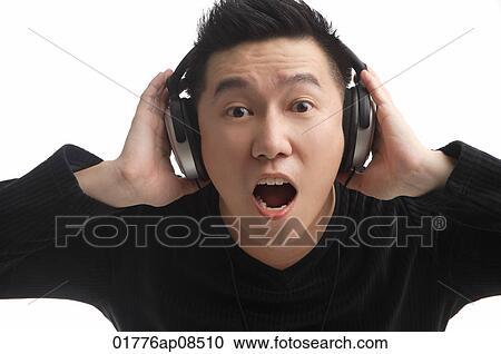 Man with headphones looking surprised at camera View Large Photo Image Stock Image - Man with headphones looking surprised at camera. Fotosearch