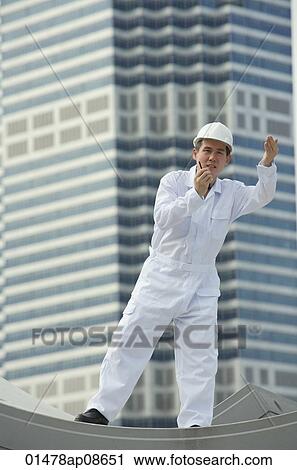 Man with walkie talkie giving directions View Large Photo Image Stock Image - Man with walkie talkie giving directions. Fotosearch